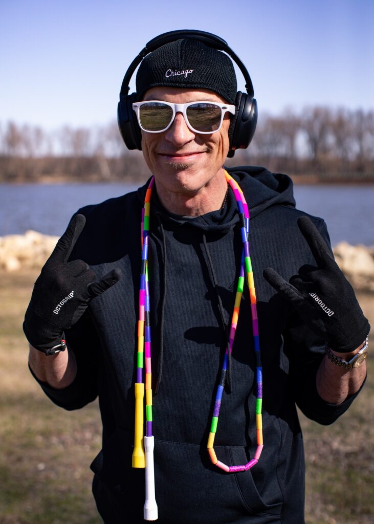 Dizzy in a hoodie and hat with headphones on at Colville Park in Red Wing, Minnesota, while throwing the horns.
