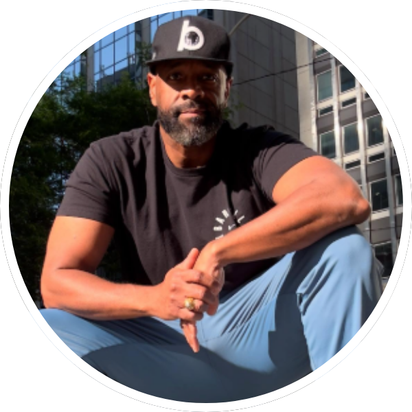 Nick Smith - @nicksmithnews posing in blue jeans, black t-shirt, black hat