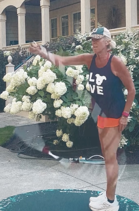 Sarah Caldwell jump rope release in front of white blooming hydrangeas